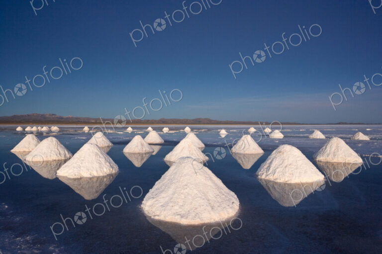 Piles of salt dry in the arid atmosphere of Bolivias Salar de Uyuni.